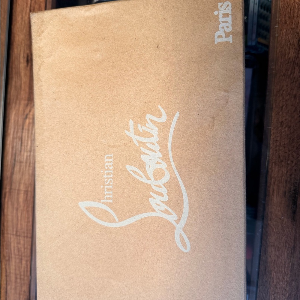 Christian Louboutin Pumps with Beige Box for storage.